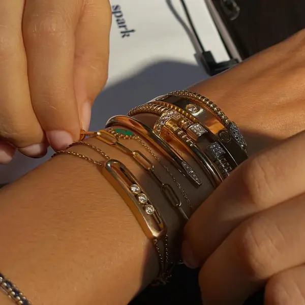 Several welded bracelets on two wrists